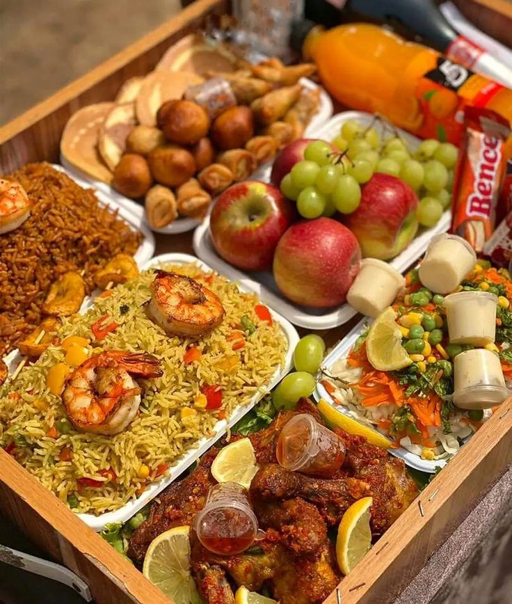 A food basket with juice, fruit and assorted snacks